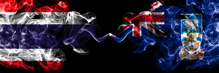 Thailand, Thai vs British, Britain, Falkland Islands smoky mystic flags placed side by side. Thick colored silky abstract smokes flags.
