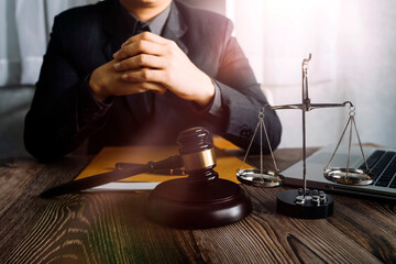 Business and lawyers discussing contract papers with brass scale on desk in office. Law, legal...