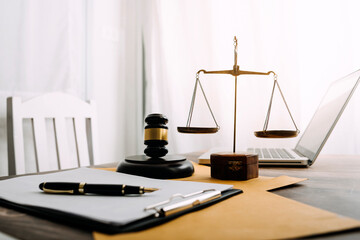 justice and law concept.Male judge in a courtroom on wooden table and Counselor or Male lawyer working in office. Legal law, advice and justice concept.