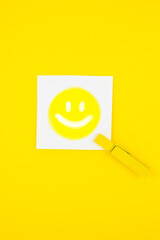Smile on the white To Do List Sticker with yellow wooden clothespin. Reminder note paper on the...
