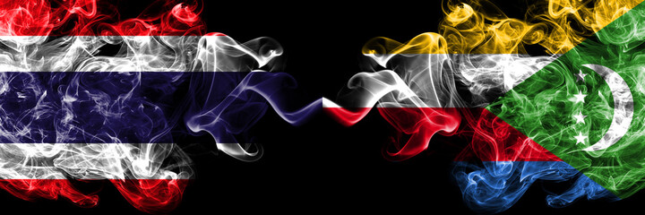 Thailand, Thai vs Comoros, Comorian smoky mystic flags placed side by side. Thick colored silky abstract smokes flags.