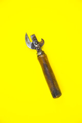 Old wooden corkscrew..Bottle opener close up on yellow background.