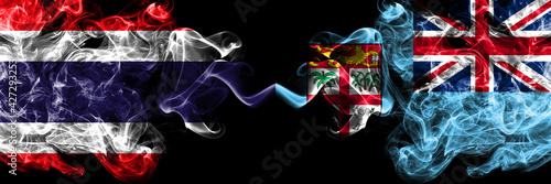 Thailand, Thai vs Fiji, Fijian smoky mystic flags placed side by side. Thick colored silky abstract smokes flags.