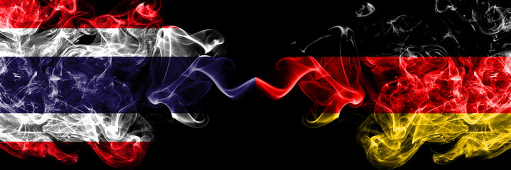 Thailand, Thai vs Germany, German, Deutschland smoky mystic flags placed side by side. Thick colored silky abstract smokes flags.