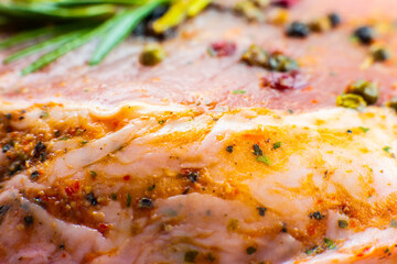 Raw Pork meat with spices and green rosemary herb. Red meat texture background, Raw ham. Macro photo. Fat Fresh juicy steak.