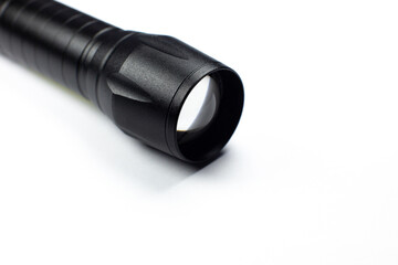 Black Flashlight on the white background. Close up.