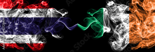 Thailand, Thai vs Ireland, Irish smoky mystic flags placed side by side. Thick colored silky abstract smokes flags.