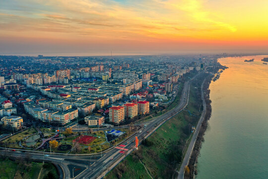 Galati, ROMANIA - March 19, 2021: Aerial view of Galati City, Romania. Danube River near city with sunrise warm light