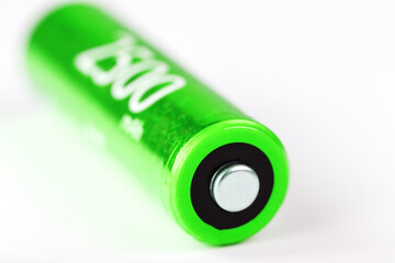 Green AA battery 2500 milliampere battery on a gray background