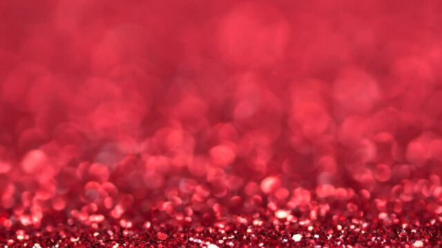Brilliant background for Christmas and new year holiday. Red moving sniny sequins rhinestones and particles create a beautiful magic bokeh