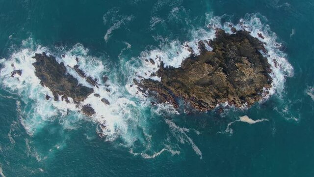 Serene aerial seascape rocky islands by Menganti beach in Kebumen, Indonesia