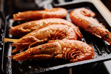 Grilled large shrimps with lemon and spices on the grill pan