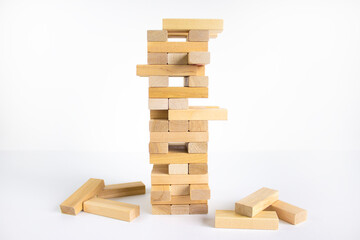 Wood block tower with architecture model. Concept Risk of management and strategy plan, growth business success process and team work. Beautiful white background, copy space.