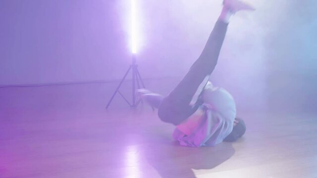 Cyber break-dance under neon lights and smoke slowmo 4K