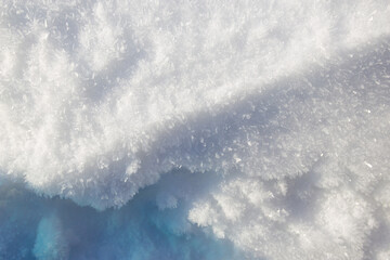 Snow texture background, natural white snow powder in winter on a bright sunny day