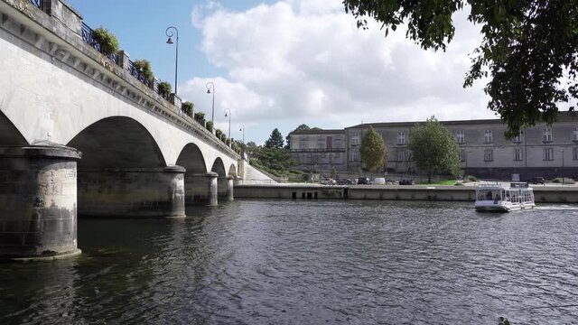 Passenger boat turning around in front of the Pont-Neuf bridge in Cognac, Charente, South of France