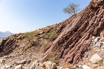 Red limestone and dolomite rock formations in Hajar Mountains on Arabian Peninsula, United Arab Emirates, Hatta.