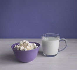 Curd in a bowl and a glass of kefir. Horizontal orientation, place for text.