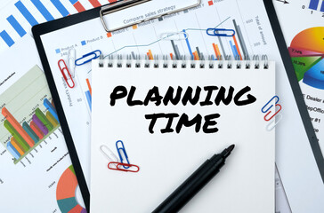 On the table are reports, charts, a notebook with the inscription - PLANNING TIME