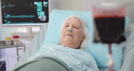Senior woman patient having blood transfusion in hospital - Powered by Adobe