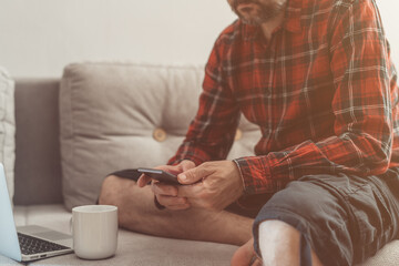 Man using mobile phone while working at home