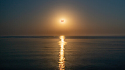 Super full blood moon and moon light over the sea