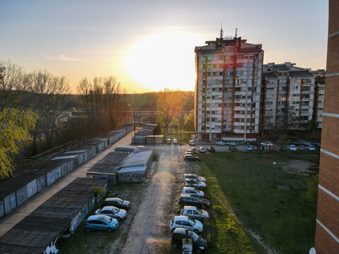 Too Many Cars Without Parking Spaces In The City. Empty Parking Lots, Aerial View. Parked Cars On A Green Area With Sunset