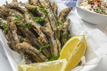 Traditional fried anchovies with lemon and parsley