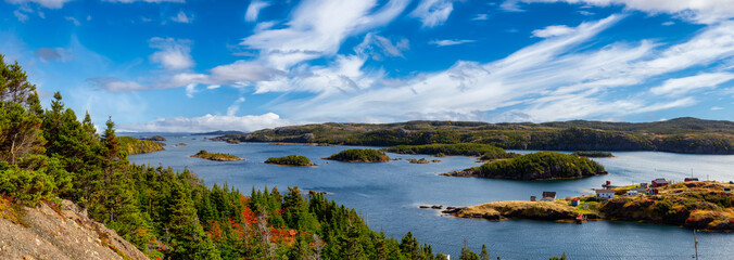 Fototapeta premium Panoramic View of a Canadian Landscape and a small town on the Atlantic Ocean Coast. Colorful Blue Sky Art Render. Taken in Pikes Arm, Newfoundland and Labrador, Canada.