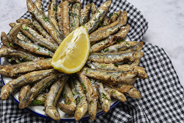 Traditional fried anchovies with lemon and parsley