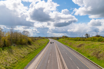 Countryside lanscape. Empty motorway and cloudy sky .