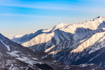 Elbrus region in the sunlight. A large valley among the steep Caucasus mountains.