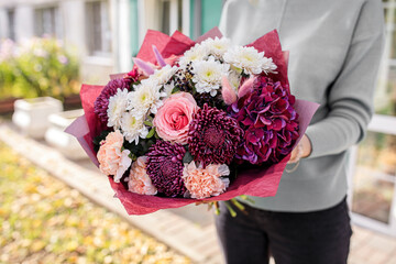 Large beautiful bouquet of mixed flowers in woman hand. Floral shop concept . Handsome fresh bouquet. Flowers delivery.