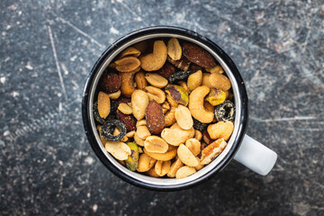 Mix of salted nuts in cup.