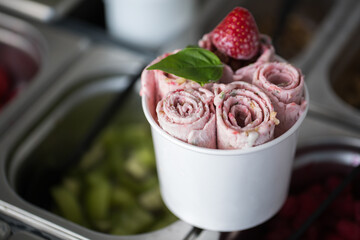 Stir-fried ice cream rolls at freeze pan. Rolled ice cream, hand made ice cream dessert. Fried ice...