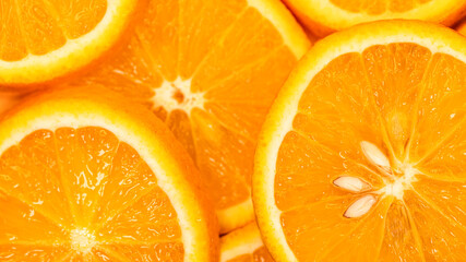 slices of orange fruit, top view. Orange background texture