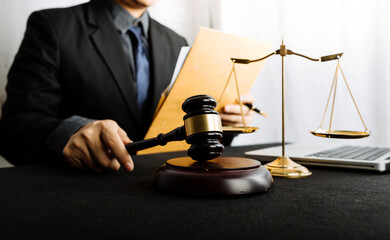 Business and lawyers discussing contract papers with brass scale on desk in office. Law, legal services, advice, justice and law concept picture with film grain effect