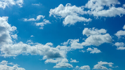 Naklejka na ściany i meble Beautiful blue sky with white clouds as a natural background