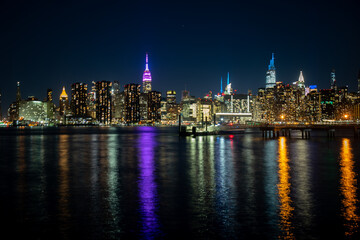Fototapeta na wymiar The lights of Midtown Manhattan reflected into the East River at night