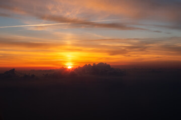 Fototapeta na wymiar Sunrise and dramatic clouds at 20,000 feet 