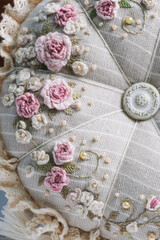 Decorative pillow with embroidered flowers close-up. High quality photo