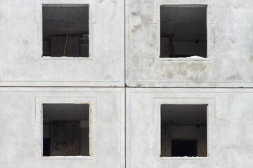 Obraz na płótnie Canvas a house under construction made of concrete panels with gray windows