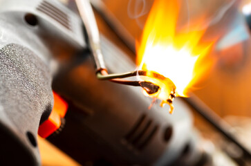 Burning wires on parts of an electrical appliance in a repair shop. Power tool repair