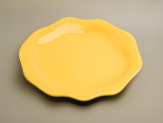 Yellow plate angular shape on gray background 