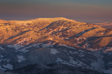 Winter morning in Gorce on the tower on the top of Lubań. A beautiful, romantic atmosphere with a view of the Pieniny Mountains, the Beskids and the Tatra Mountains.
