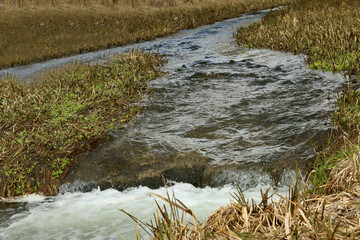 A river with a small waterfall