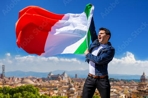 proud Man waving Italian flag Against the blue sky national holiday Liberation or Republic Day.