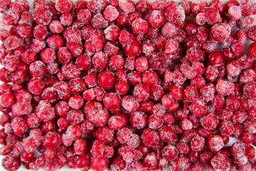Berries of red currant quick-frozen pink red color with white frost, useful products vitamins. © Victor1153