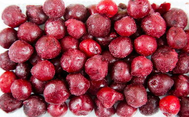 Cherry berries are quick-frozen dark red with white frost, useful products are vitamins.