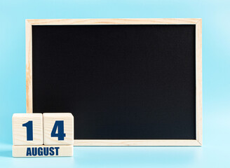 August 14th. Day 14 of month, Cube calendar with date, empty frame on light blue background. Place for your text. Summer month, day of the year concept